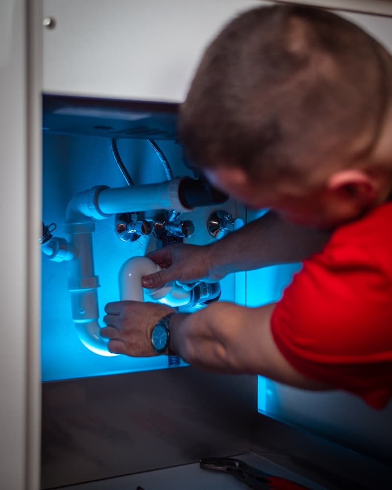 Plumber fixing pipes